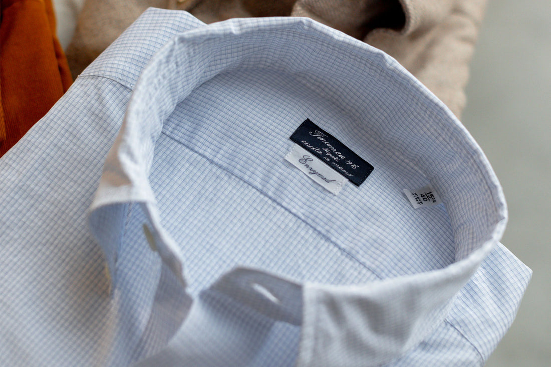 Close-up of the label inside a men's dress shirt showing the brand and size.