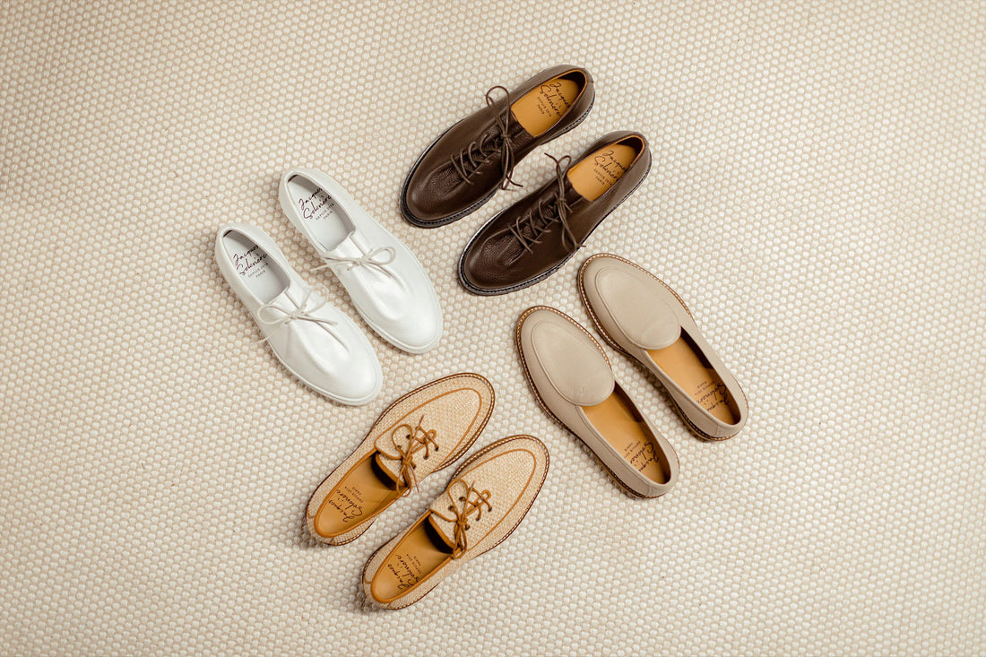Five pairs of shoes arranged neatly on a textured surface.