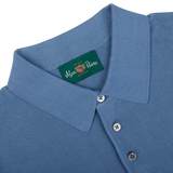 Close-up of an Airforce Blue Knitted Cotton Polo Shirt collar with an Alan Paine brand label.