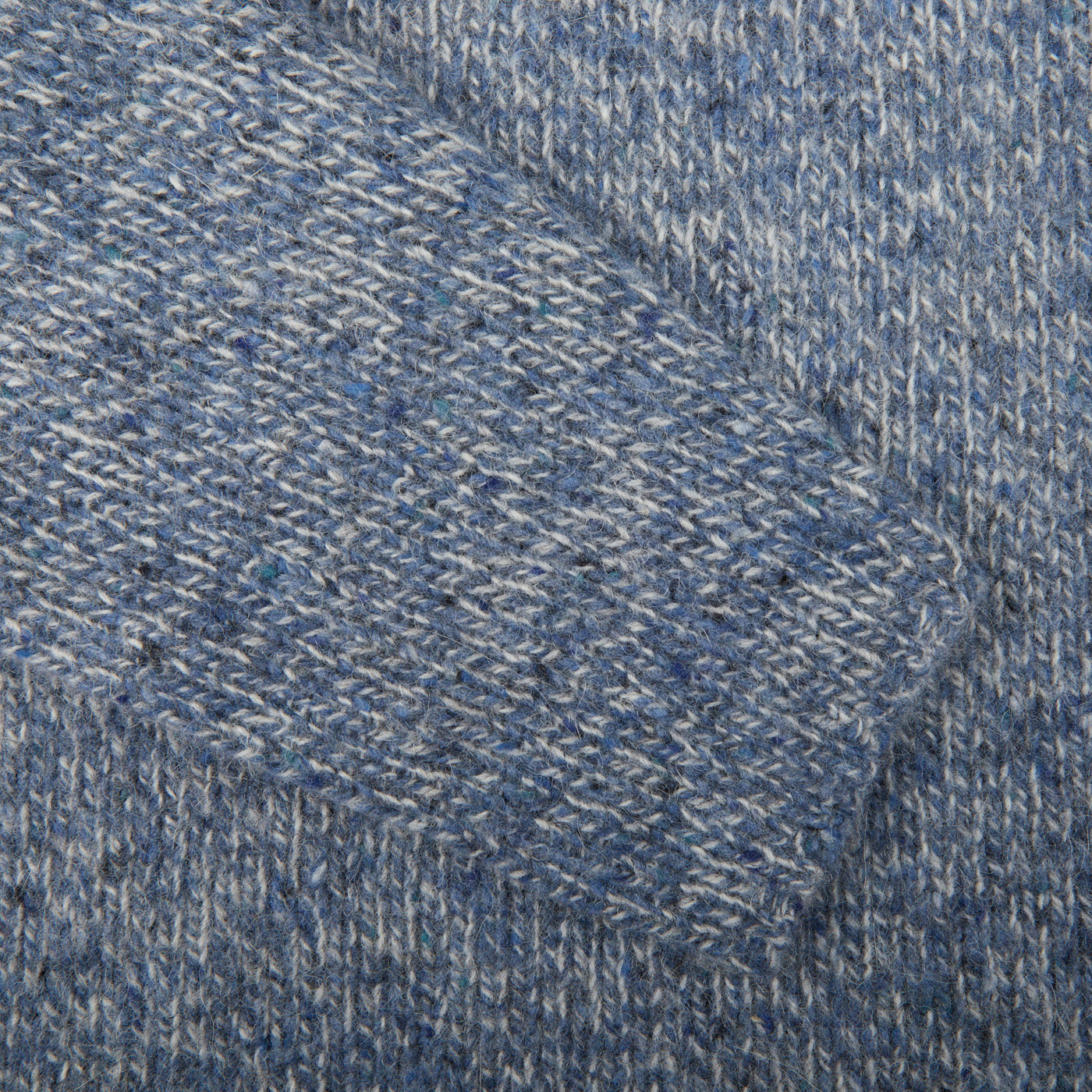 A close up of an Alan Paine Blue Spreckle Wool Alpaca Tweed Roll Neck sweater with a roll-neck.