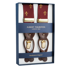 Albert Thurston classic Bordeaux with Gold French Lily 35 mm braces with gold-tone hardware and brown leather accents, displayed in an open box labeled "Handmade in England.