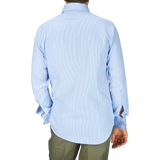 The man is wearing an Alexander Kraft Monte Carlo Blue White Bengal Stripe Cotton Double Cuff Shirt with a fitted cut.