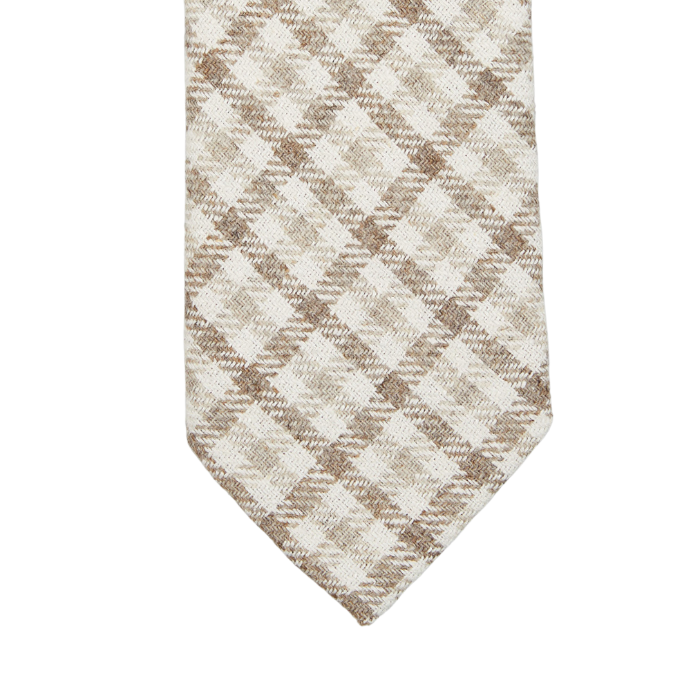 A close-up of a Brown Checked Wool Silk Lined Tie with a brown and white checkered pattern, by Amanda Christensen.