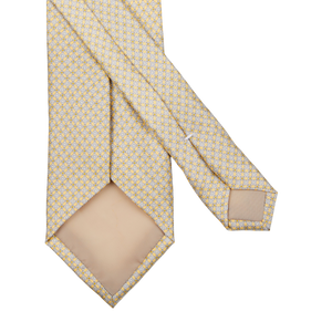 Yellow and white polka dot pure silk tie
could be rewritten as: 
Yellow Micro Medallion Printed Silk Lined Tie by Amanda Christensen.