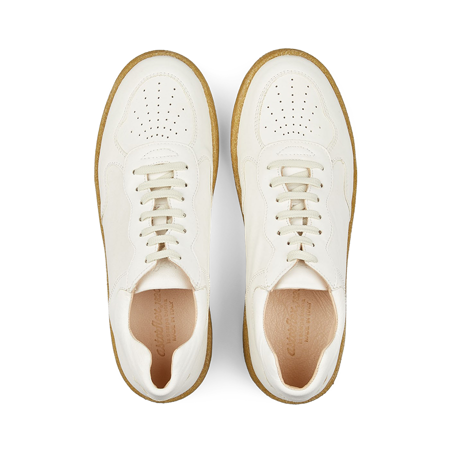 Pair of White Leather Tenniflex Sneakers by Astorflex (top view) on a striped background.