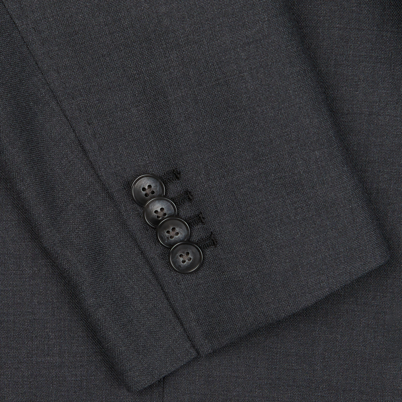 Close-up of a Baltzar Sartorial Grey Super 100's Wool Suit Jacket sleeve with four black buttons.
