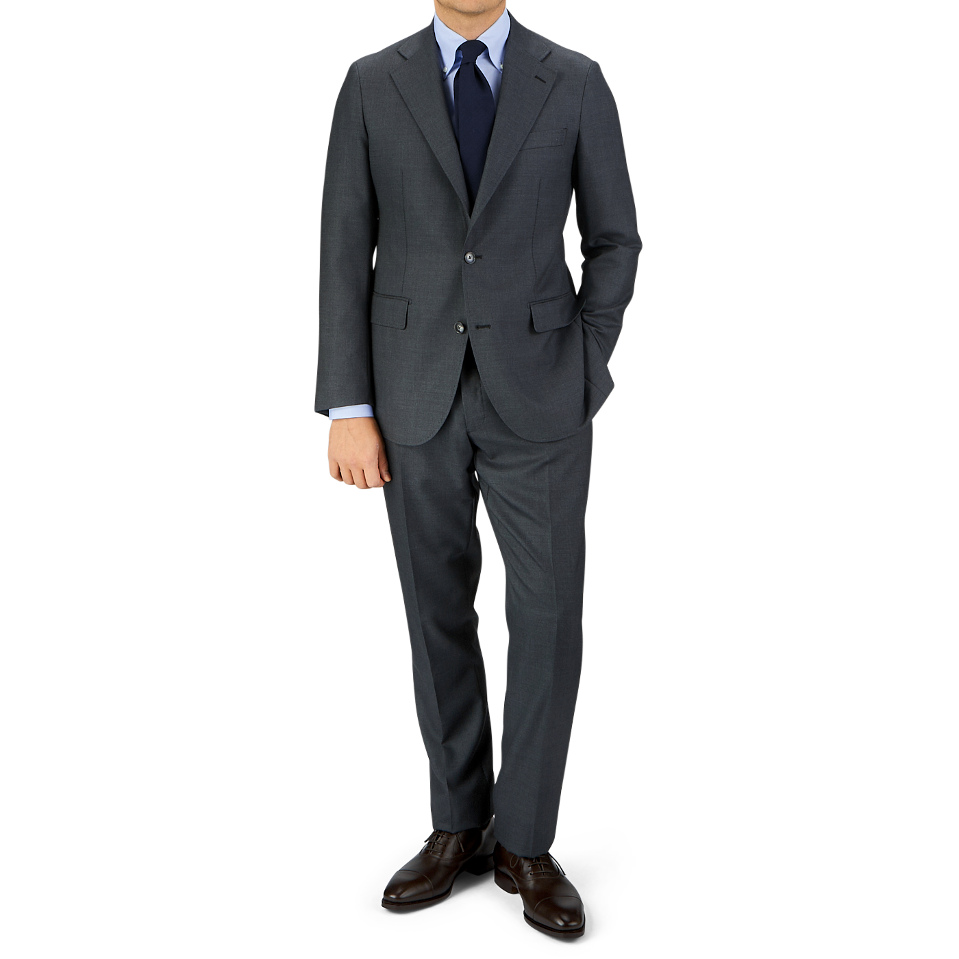 Man in a Grey Super 100's Wool Suit Jacket blazer with a blue tie standing against a gray background. (Baltzar Sartorial)