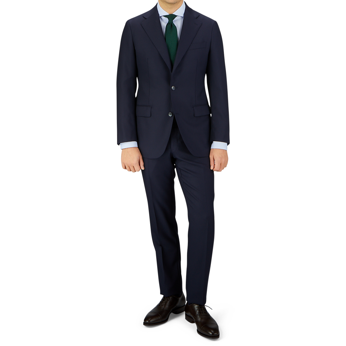 Man in a Baltzar Sartorial navy Super 100's wool suit jacket, white shirt, and green tie standing against a grey background with colorful geometrical pattern at the bottom.