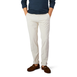 A man in slim fit Light Beige Cotton Stretch Chinos from Berwich and a blue cotton shirt.