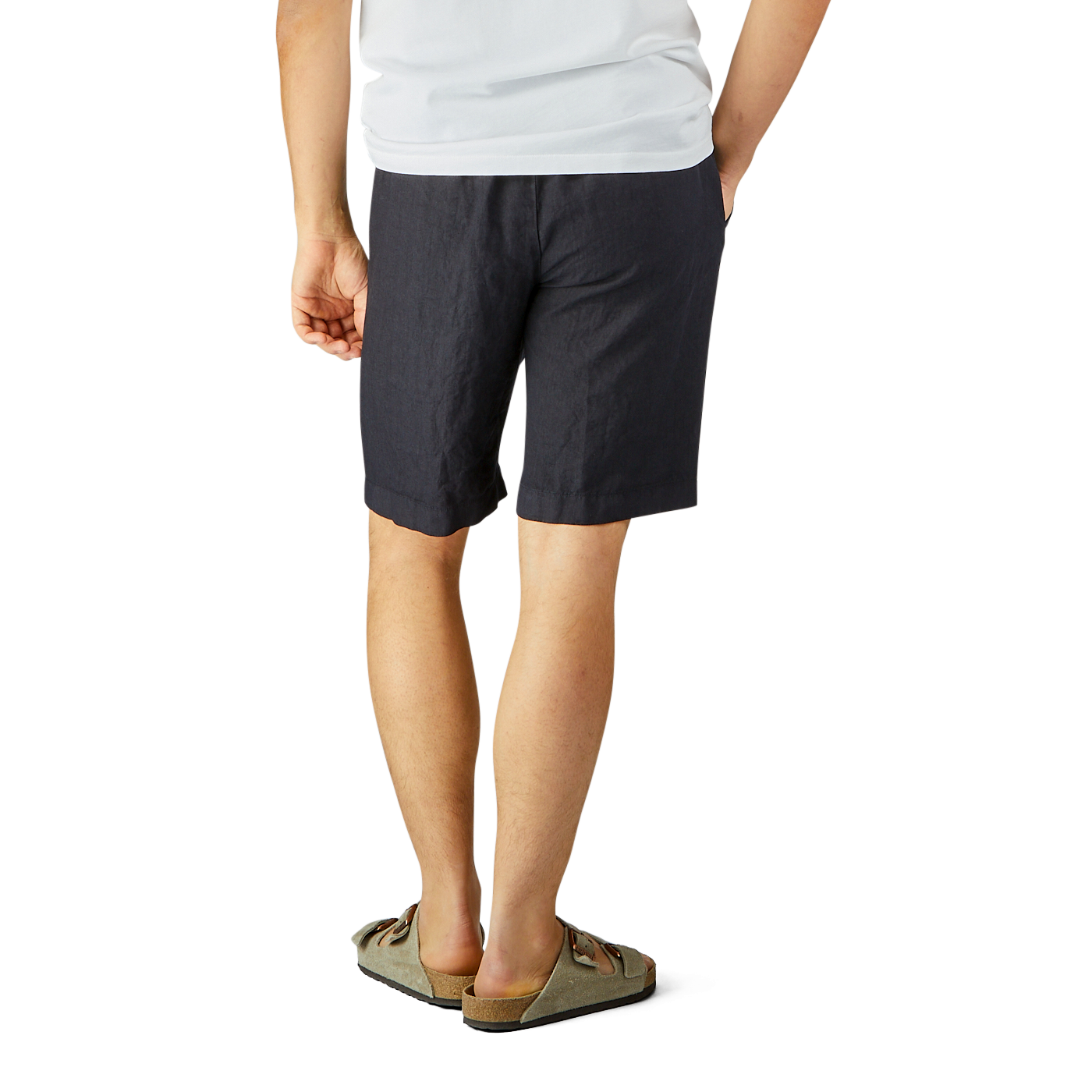 Man standing in Berwich navy blue washed linen drawstring shorts and a white t-shirt, wearing slip-on shoes, against a plain background.