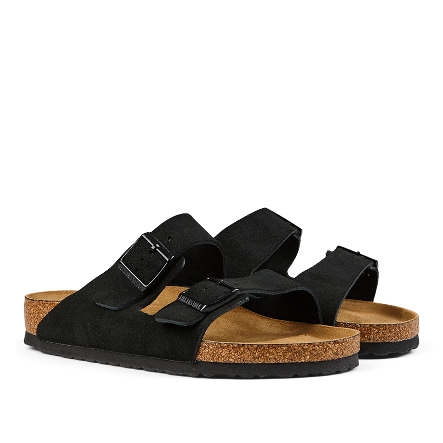 A pair of black suede leather Birkenstock Arizona sandals with two straps, buckles, and cork footbeds.