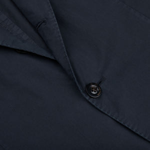 Close-up of a dark button fastened on a navy blue Boglioli Dark Blue Washed Cotton K Jacket with visible stitching details indicative of unstructured craftsmanship.