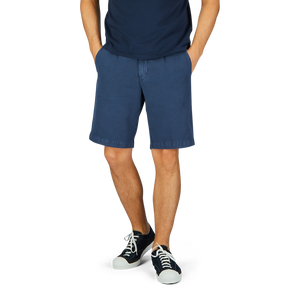 Man standing in a Briglia navy blue cotton linen pleated shorts with an adjustable waistband against a plain background.