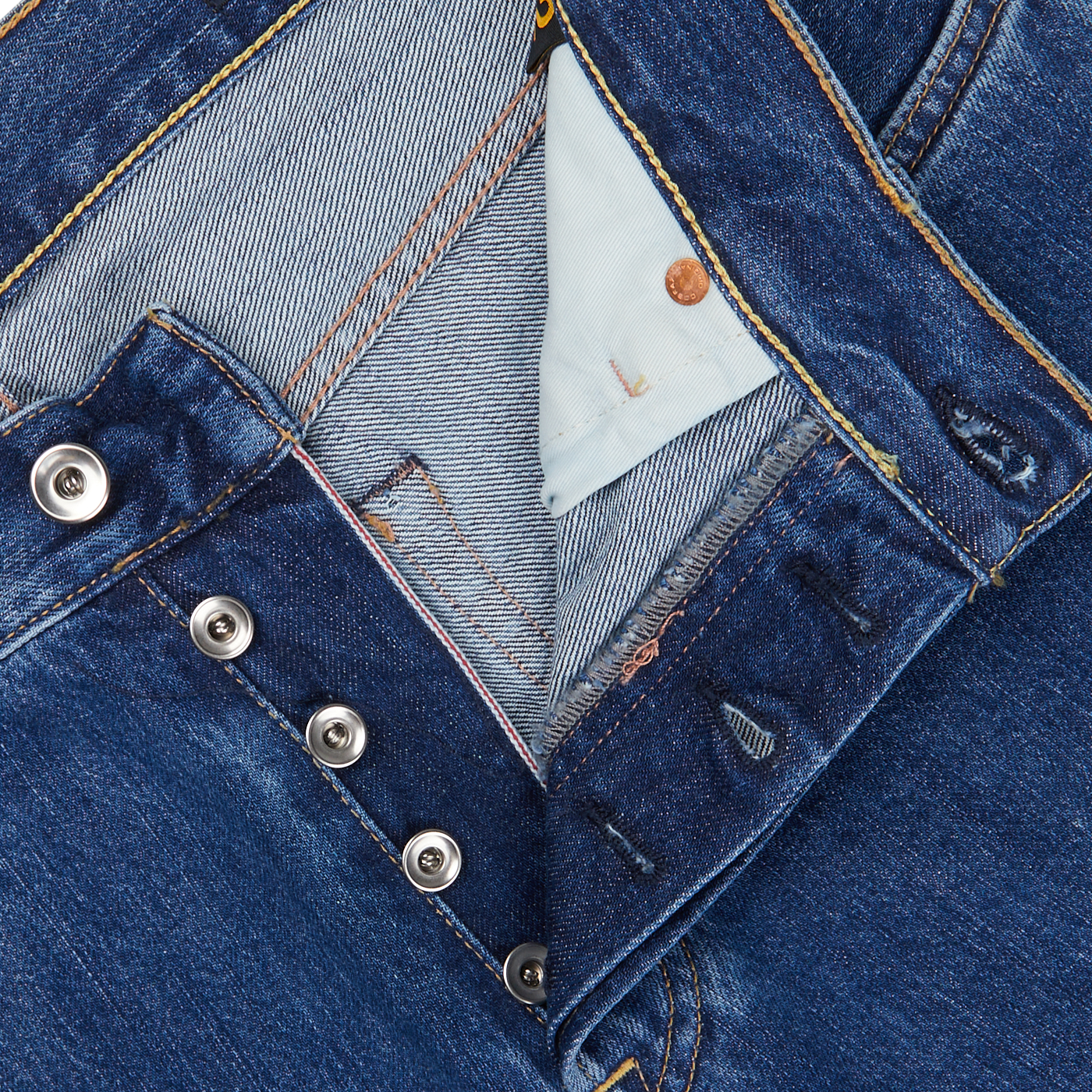 Close-up of a blue denim jacket made from C.O.F Studio's Blue Organic Kurioki Cotton M7 6x Wash Jeans with silver snap buttons and visible stitching details.