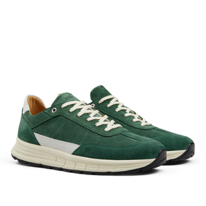 A pair of CQP Court Green Suede Leather Renna Sneakers with white laces and a white leather detail on the side, featuring a VIBRAM sole.