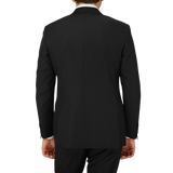The back view of a man in a timeless Black Virgin Wool Twill Suit by Canali, with a structured shoulder.