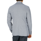 The back view of a man wearing a Canali Light Grey Houndstooth Cotton Jersey Blazer with casual tailoring.