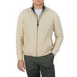 A man wearing a Canali Navy Blue Beige Reversible Technical Gilet and khaki pants.