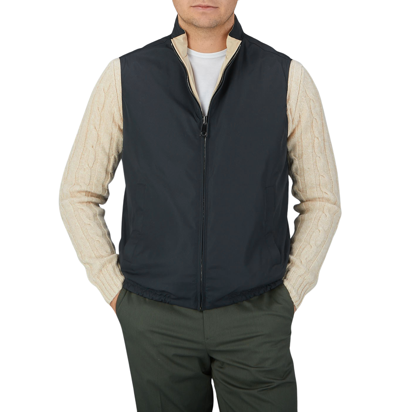 A Canali man with his hands in his pockets wearing the Navy Blue Beige Reversible Technical Gilet.