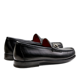 A pair of Black Funchal Leather Xim horsebit loafers by Carmina on a white background.