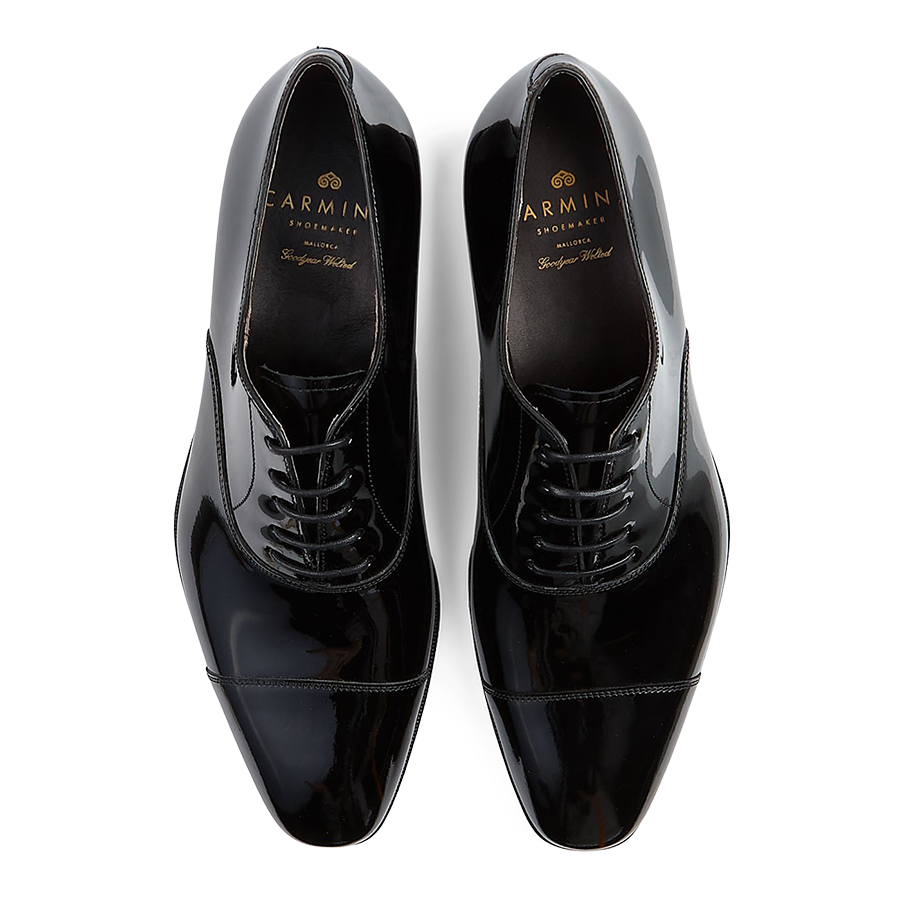 A pair of black, polished, Goodyear welted, lace-up Carmina dress shoes.
