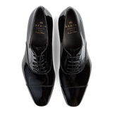 A pair of black, polished, Goodyear welted, lace-up Carmina dress shoes.