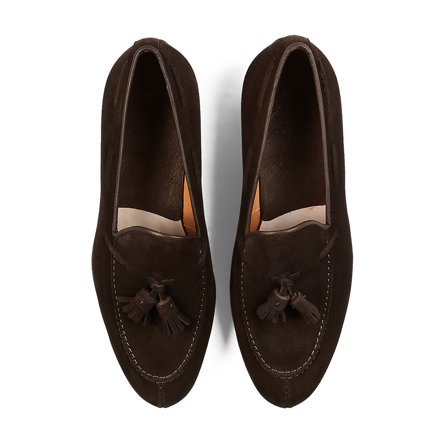 A pair of Brown Suede Forest Tassel Loafers by Carmina displayed on a striped background.
