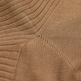 Close-up view of a textured brown fabric with detailed ribbing patterns, crafted from Faon Beige Cotton Fil d'Ècosse Ribbed Socks by Doré Doré.