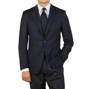 A man is posing for a photo in a Dreaming Of Monday Navy Blue 7-Fold Super 100s Wool Tie.