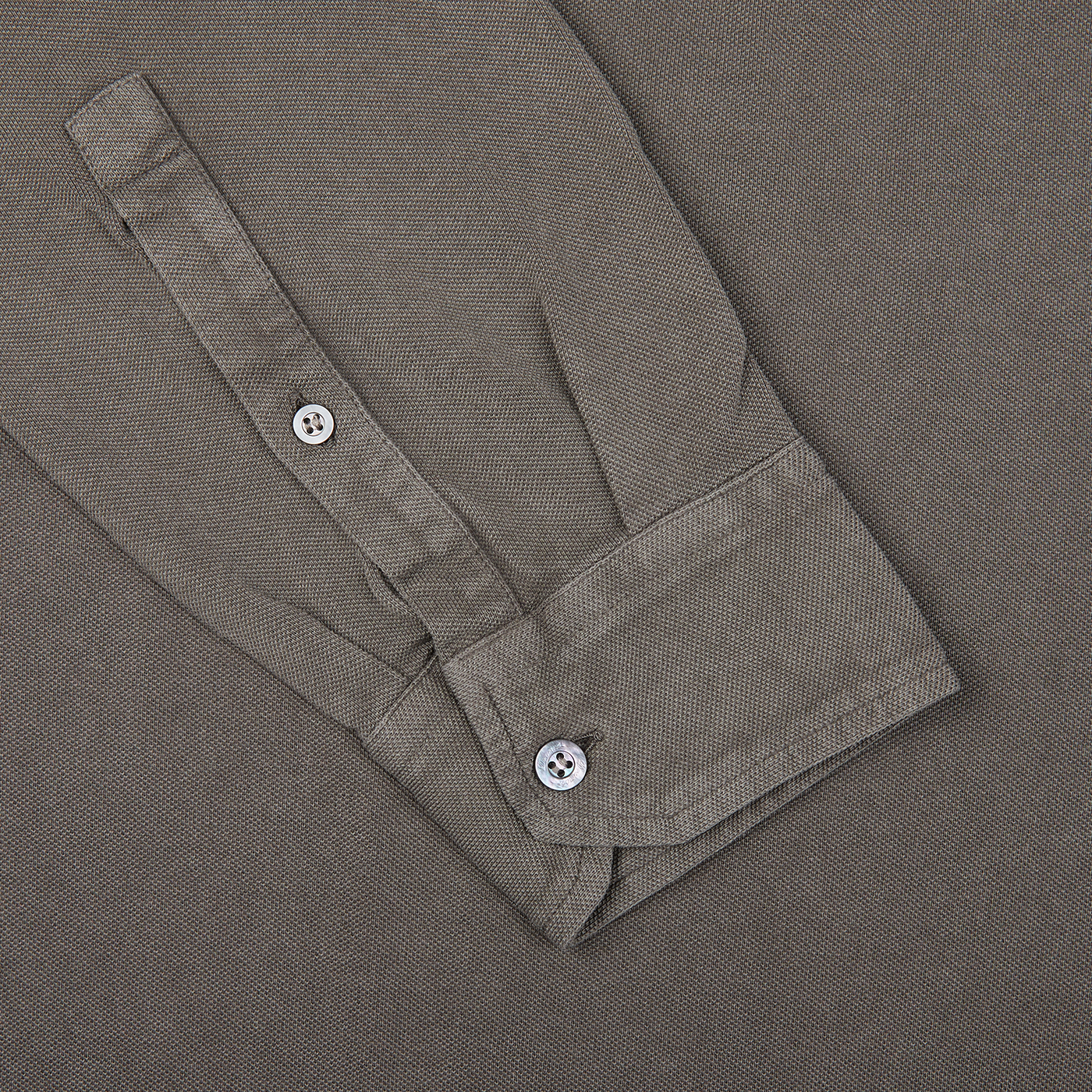 A close up of a brown grey cotton piquet LS polo shirt from Italy by Drumohr, featuring buttons.