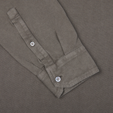 A close up of a brown grey cotton piquet LS polo shirt from Italy by Drumohr, featuring buttons.