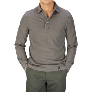 A man wearing a Drumohr Brown Grey Cotton Piquet LS Polo Shirt from Italy and green pants.