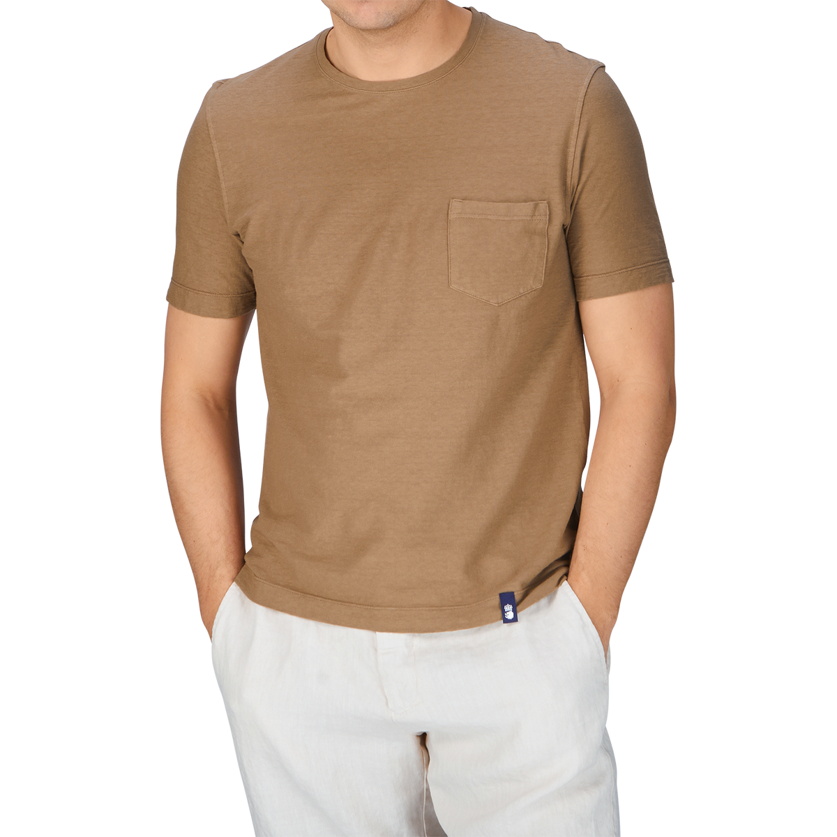 A man wearing a Drumohr Coffee Brown Cotton Linen T-shirt and white pants from Italy.