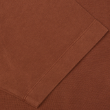 Close-up of a coffee brown Drumohr cotton piquet polo shirt with detailed stitching.
