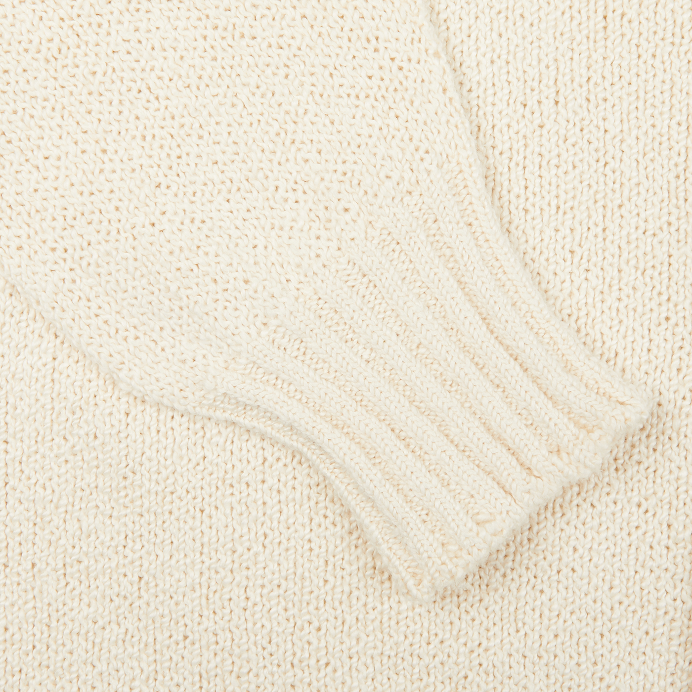 A close up of a luxurious Drumohr Ecru White Knitted Cotton Cardigan.