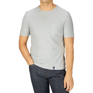 A man wearing a Light Grey Cotton Linen T-Shirt and jeans from Italy.