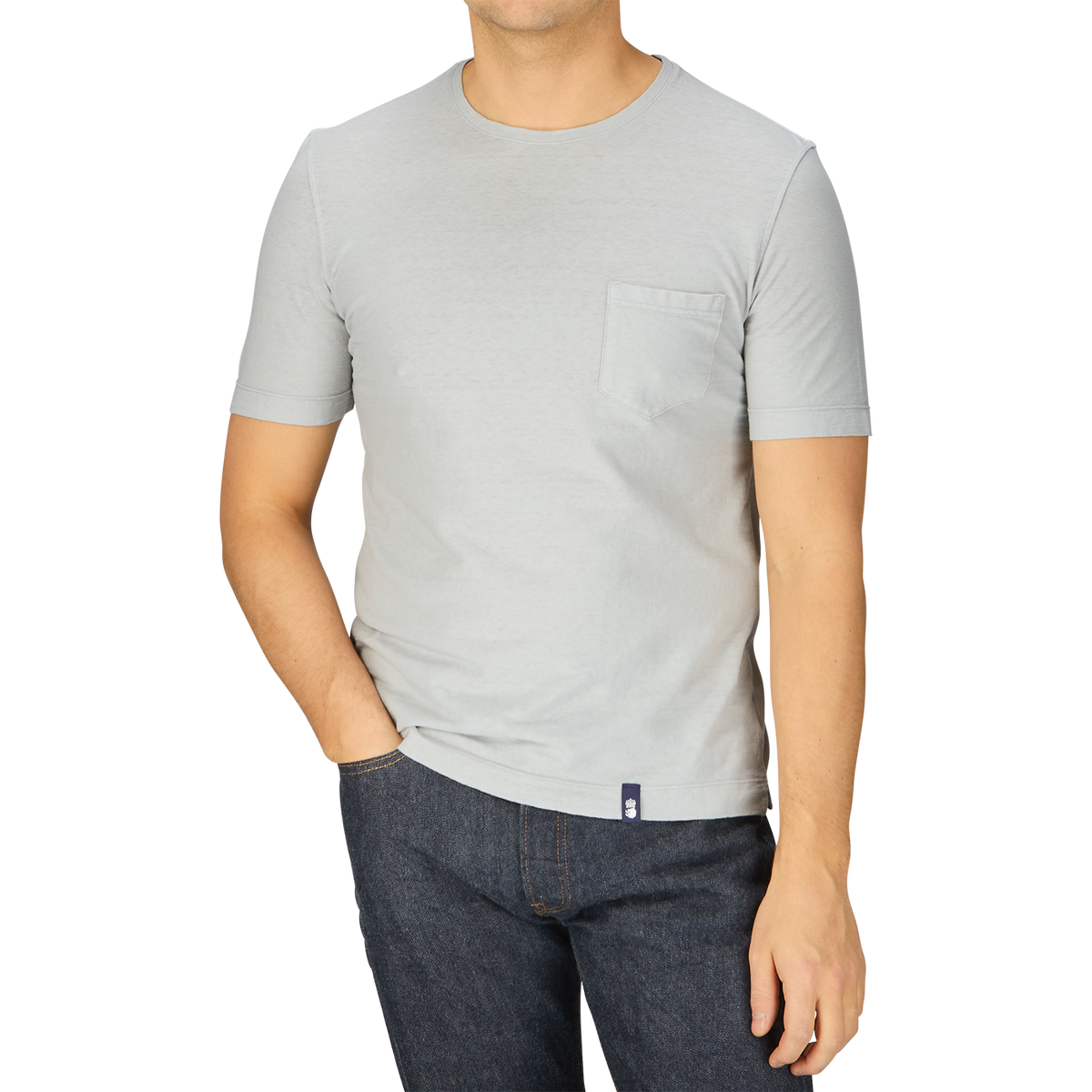 A man wearing a Light Grey Cotton Linen T-Shirt and jeans from Italy.