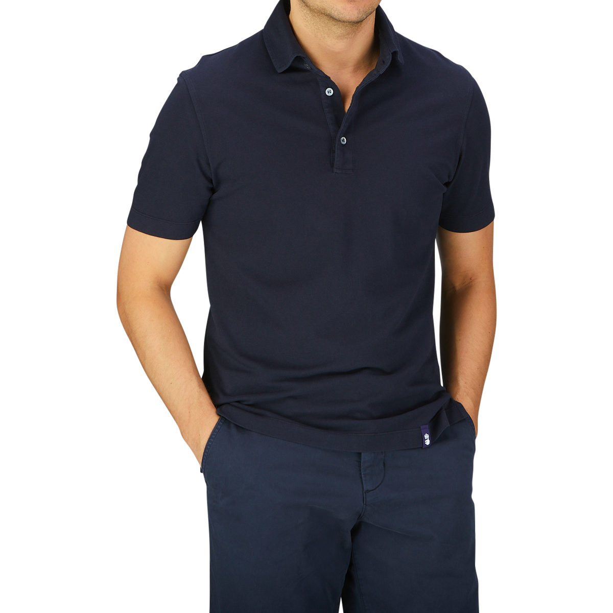 Man standing with hands on hips wearing a dark blue Drumohr Navy Blue Cotton Piquet Polo Shirt and navy trousers.
