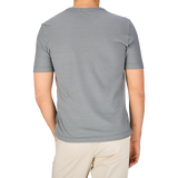 The man is wearing a Steel Grey Cotton Linen T-Shirt from Drumohr.