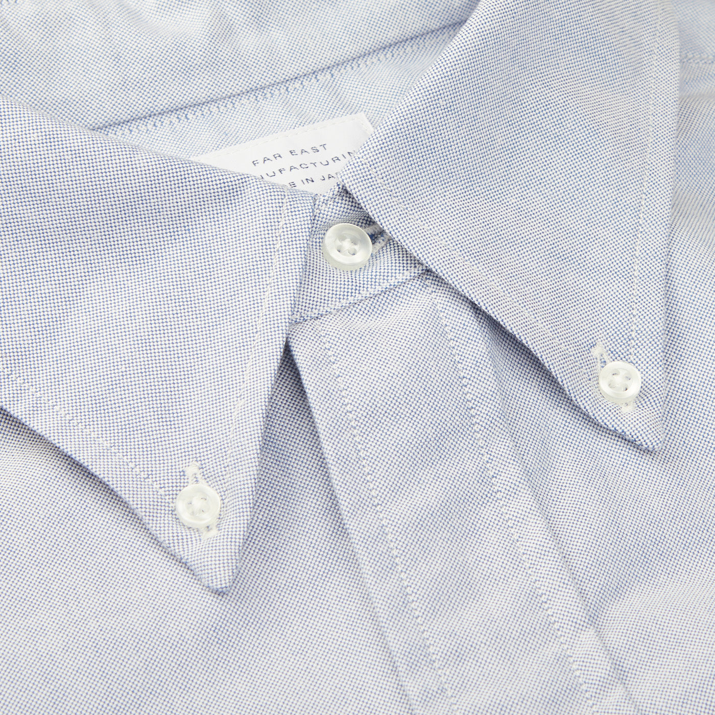 A close up of a Far East Manufacturing light blue cotton Oxford BD regular shirt.