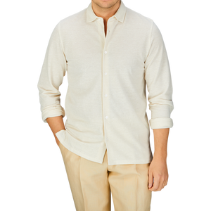 Man wearing a Fedeli Ecru Cotton Linen Piquet Polo Shirt and beige trousers.
