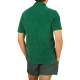 The back view of a man wearing a Fedeli Grass Green Cotton Towelling Polo Shirt.