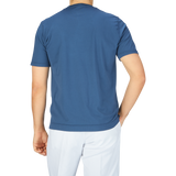 The back view of a man wearing a Fedeli Indigo Blue Organic Cotton T-Shirt.