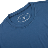The back of a luxury Indigo Blue Organic Cotton T-Shirt by Fedeli with a white logo on it.