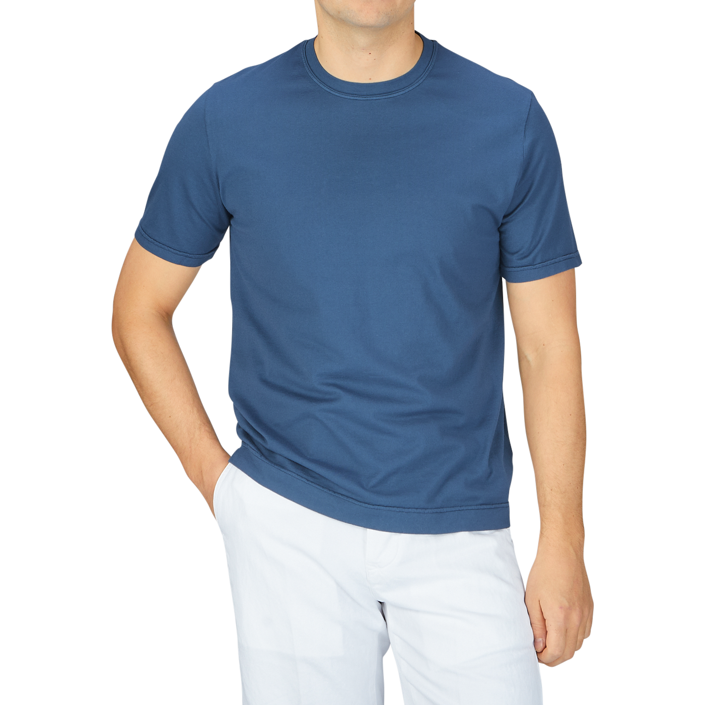A man wearing a Fedeli Indigo Blue Organic Cotton T-Shirt and white pants.