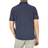 The back view of a man wearing a Fedeli Navy Blue Organic Cotton Polo Shirt.