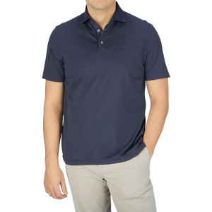 A man wearing a Fedeli Navy Blue Organic Cotton Polo Shirt and khaki pants.