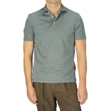 A man in a Fedeli Olive Green Organic Cotton Polo Shirt.