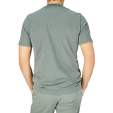 The back view of a man wearing a Fedeli Olive Green Organic Cotton T-Shirt.