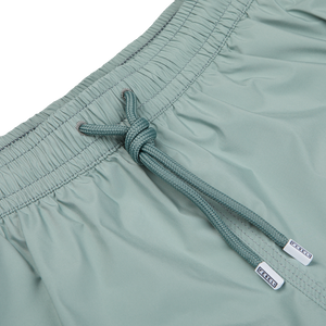 Close-up of a teal drawstring on Fedeli Sage Green Madeira Microfiber Swim Shorts with visible brand tags.